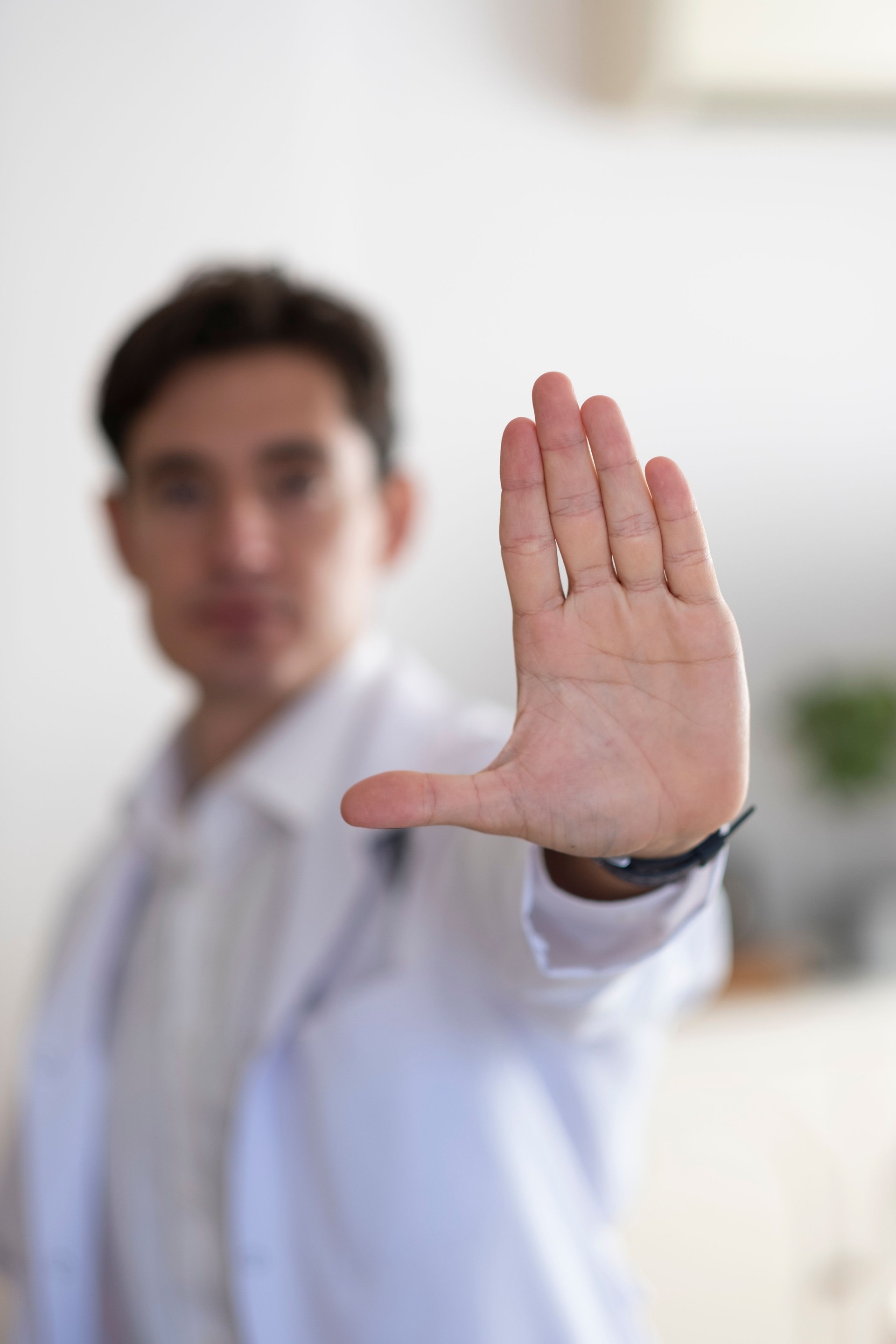 Doctor making a stop sign with his hand